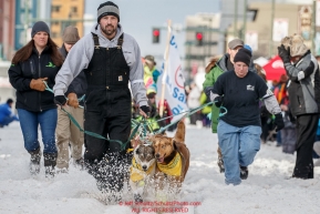 Monica Zappa's handlers bring her team down 4th avenue to the start line during the Ceremonial Start of the 2016 Iditarod in Anchorage, Alaska.  March 05, 2016