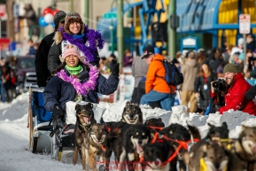 Jodi Bailey and her Iditarider are all smiles as they run down 4th avenue after leaving  the Ceremonial Start line of the 2016 Iditarod in Anchorage, Alaska.  March 05, 2016