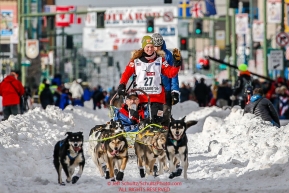 Sigrid Ekran runs down 4th avenue during the Ceremonial Start of the 2016 Iditarod in Anchorage, Alaska.  March 05, 2016