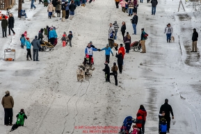 Linwood Fiedler gives high-fives as he runs down Cordova Street in downtown Anchorage during the Ceremonial Start of the 2016 Iditarod in Anchorage, Alaska.  March 05, 2016