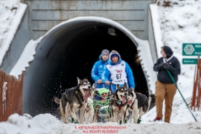 Jason Mackey's team comes through the tunnel under Gambell Street during the Ceremonial Start of the 2016 Iditarod in Anchorage, Alaska.  March 05, 2016