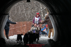 Sarah Stokey runs through the tunnel under Gambell Street during the Ceremonial Start of the 2016 Iditarod in Anchorage, Alaska.  March 05, 2016