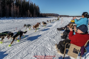 Spectators clap and cheer on Monica Zappa on Long Lake during the Restart of the 2016 Iditarod in Willow, Alaska.  March 06, 2016.