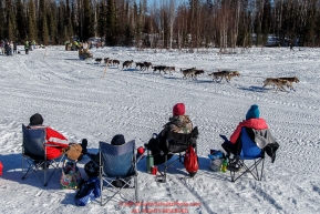 Spectators watch Rick Casillo run by on Long Lake during the Restart of the 2016 Iditarod in Willow, Alaska.  March 06, 2016.