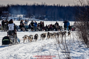 Ketil Reitan passes spectators out picnicing on Long Lake after leaving the start during the Restart of the 2016 Iditarod in Willow, Alaska.  March 06, 2016.