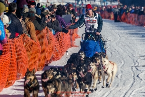 Travis Beals gives a high-five to spectators on Willow Lake during the Restart of the 2016 Iditarod in Willow, Alaska.  March 06, 2016.