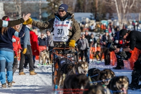 Robert Sorlie gives a high-five as he leaves the start line during the Restart of the 2016 Iditarod in Willow, Alaska.  March 06, 2016