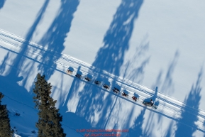 A team runs through tree shadows on the trail along the Tanana river between Fairbanks and Nenana during the 2017 Iditarod on Monday March 6, 2017.Photo by Jeff Schultz/SchultzPhoto.com  (C) 2017  ALL RIGHTS RESVERVED