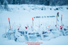 Musher food drop bags await their arrival at the Nikolai checkpoint as Ryan Redington approaches on the river during the 2018 Iditarod race on Tuesday March 06, 2018. Photo by Jeff Schultz/SchultzPhoto.com  (C) 2018  ALL RIGHTS RESERVED