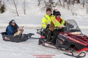 Volunteers take a drop dog to the airstrip by snowmachine at the Finger Lake checkpoint during Iditarod 2016.  Alaska.  March 07, 2016.  Photo by Jeff Schultz (C) 2016 ALL RIGHTS RESERVED