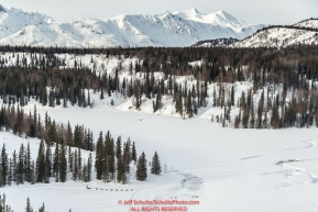 Teams run on Red Lake just after leaving the Finger Lake checkpoint on their way to the Rainy Pass checkpoint during Iditarod 2016.  Alaska.  March 07, 2016.  Photo by Jeff Schultz (C) 2016 ALL RIGHTS RESERVED