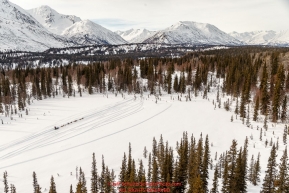 A teams runs on a lake on the trail between the Finger Lake and Rainy Pass checkpoint during Iditarod 2016.  Alaska.  March 07, 2016.  Photo by Jeff Schultz (C) 2016 ALL RIGHTS RESERVED