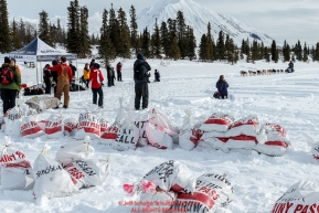 Mike Williams Jr. arrives on Puntilla Lake at the Rainy Pass Checkpoint with musher drop bags in the foreground during Iditarod 2016.  Alaska.  March 07, 2016.  Photo by Jeff Schultz (C) 2016 ALL RIGHTS RESERVED