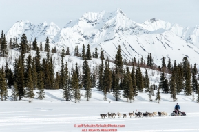 Noah Burmeister runs on Puntilla Lake with the Alaska Range in the background at the Rainy Pass Checkpoint during Iditarod 2016.  Alaska.  March 07, 2016.  Photo by Jeff Schultz (C) 2016 ALL RIGHTS RESERVED