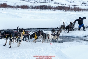 John Baker crosses the open water of the Happy River in Ptarmigan Valley on the way to Rohn from the Rainy Pass checkpoint during Iditarod 2016.  Alaska.  March 07, 2016.  Photo by Jeff Schultz (C) 2016 ALL RIGHTS RESERVED