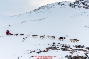 Aliy Zirkle at the summit of Rany Pass on the trail in the Alaska Range after leaving the Rainy Pass Checkpoint on the way to Rohn during Iditarod 2016.  Alaska.  March 07, 2016.  Photo by Jeff Schultz (C) 2016 ALL RIGHTS RESERVED