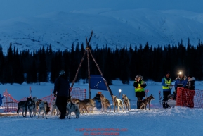 Volunteers check in Linwood Fiedler in the morning at the Finger Lake checkpoint at Winterlake Lodge during Iditarod 2016.  Alaska.  March 07, 2016.  Photo by Jeff Schultz (C) 2016 ALL RIGHTS RESERVED