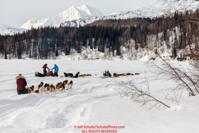 Michelle Phillips runs down the Skwentna River as Lance and Jason Mackey rest their teams during the 2016 Iditarod between the Finger Lake and Rainy Pass Checkpoints.  Alaska.  March 07, 2016.  Photo by Jeff Schultz (C) 2016 ALL RIGHTS RESERVED