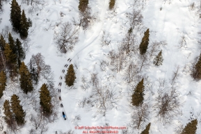 A team snakes their way through the woods near the Happy River steps during the 2016 Iditarod Trail between the Finger Lake and Rainy Pass Checkpoints.  Alaska.  March 07, 2016.  Photo by Jeff Schultz (C) 2016 ALL RIGHTS RESERVED