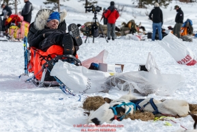 Ralph Johannessen naps on his sled on Puntilla Lake at the Rainy Pass Checkpoint during Iditarod 2016.  Alaska.  March 07, 2016.  Photo by Jeff Schultz (C) 2016 ALL RIGHTS RESERVED