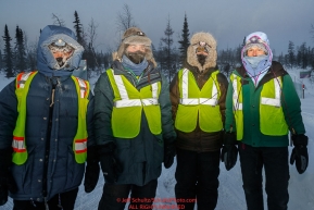 Four volunteers brave the sub-zero temperatures to protect the saftery of the dogs and mushers at the checkpoint in Manley Hot Springs during the 2017 Iditarod on Tuesday March 7, 2017.Photo by Jeff Schultz/SchultzPhoto.com  (C) 2017  ALL RIGHTS RESVERVED
