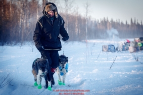Volunteer vet Dr. James Kenyon walks two dropped dogs at the checkpoint in Manley Hot Springs during the 2017 Iditarod on Tuesday March 7, 2017.Photo by Jeff Schultz/SchultzPhoto.com  (C) 2017  ALL RIGHTS RESVERVED
