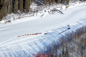 Ray Redington Jr. passes two camped teams as he runs on the trail on a slough of the Tanana River between Manley and Tanana during the 2017 Iditarod on Tuesday March 7, 2017.Photo by Jeff Schultz/SchultzPhoto.com  (C) 2017  ALL RIGHTS RESVERVED