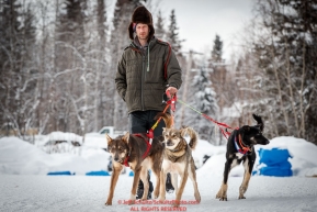 Nick Petit takes his dogs for a walk during his 24-hour layover in the afternoon at the McGrath checkpoint during the 2018 Iditarod race on Wednesday March 07, 2018. Photo by Jeff Schultz/SchultzPhoto.com  (C) 2018  ALL RIGHTS RESERVED