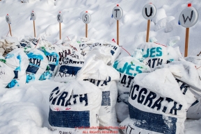 Musher food drop bags await the arrival of their owners in the afternoon at the McGrath checkpoint during the 2018 Iditarod race on Wednesday March 07, 2018. Photo by Jeff Schultz/SchultzPhoto.com  (C) 2018  ALL RIGHTS RESERVED