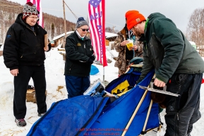 Volunteers Nell Huffman and Susan Smith check in Andy Farquar in the afternoon at the Takotna checkpoint during the 2018 Iditarod race on Wednesday March 07, 2018. Photo by Jeff Schultz/SchultzPhoto.com  (C) 2018  ALL RIGHTS RESERVED