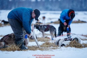 Lev Shvarts (r) and Andrew Nolan boot their dog teams in the morning at the Nikolai checkpoint during the 2018 Iditarod race on Wednesday March 07, 2018. Photo by Jeff Schultz/SchultzPhoto.com  (C) 2018  ALL RIGHTS RESERVED