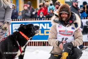 Lance Mackey talks with one of his sled dogs at the ceremonial start in Anchorage, AK of the 2020 Iditarod.