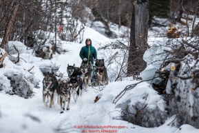 Kristin Knight Pace passes shelf ice on the trail in the Alaska Range in the Dalzell Gorge on the way to Rohn from the Rainy Pass checkpoint during Iditarod 2016.  Alaska.  March 07, 2016.  Photo by Jeff Schultz (C) 2016 ALL RIGHTS RESERVED