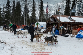 Volunteers lead Miriam Osredkar to a parking spot after she arrived at the Rohn checkpoint during Iditarod 2016.  Alaska.  March 08, 2016.  Photo by Jeff Schultz (C) 2016 ALL RIGHTS RESERVED