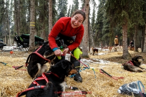 Musher Sarah Stokey boots her dogs as she prepares to leave the Rohn checkpoint during Iditarod 2016.  Alaska.  March 08, 2016.  Photo by Jeff Schultz (C) 2016 ALL RIGHTS RESERVED