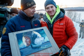 Wade Marrs recieves the Penair Spirit of Alaska award from Penair's president Danny Seybert for being the first person to the Ruby checkpoint during the 2017 Iditarod on Wednesday March 8, 2017.Photo by Jeff Schultz/SchultzPhoto.com  (C) 2017  ALL RIGHTS RESERVED