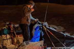 Richie Diehl brushes his teeth as he prepares to leave the Takotna checkpoint after his 24-hour layover on Thursday morning, March 8th during the 2018 Iditarod Sled Dog Race -- AlaskaPhoto by Jeff Schultz/SchultzPhoto.com  (C) 2018  ALL RIGHTS RESERVED