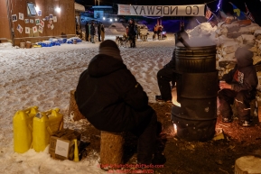 Takotna residents keep dog water hot as Aliy Zirkle prepares to leave the Takotna checkpoint after her 24-hour layover early on Thursday, March 8th during the 2018 Iditarod Sled Dog Race -- AlaskaPhoto by Jeff Schultz/SchultzPhoto.com  (C) 2018  ALL RIGHTS RESERVED
