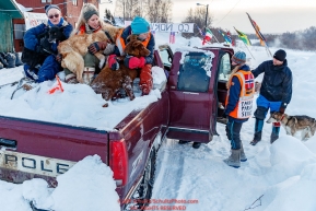 Volunteers load dropped dogs into a truck for a ride to the airport at the Takotna checkpoint on Thursday, March 8th during the 2018 Iditarod Sled Dog Race -- AlaskaPhoto by Jeff Schultz/SchultzPhoto.com  (C) 2018  ALL RIGHTS RESERVED