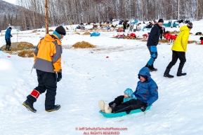 On a traveling vaction on the Iditarod Wooden Saunders and daughter sled down a hill at the Takotna checkpoint on Thursday, March 8th during the 2018 Iditarod Sled Dog Race -- AlaskaPhoto by Jeff Schultz/SchultzPhoto.com  (C) 2018  ALL RIGHTS RESERVED