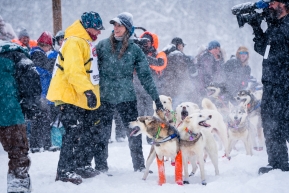 Veteran Linwood Fiedler of Willow talking with a handler at the re-start of the 2020 Iditarod in Willow, Alaska.