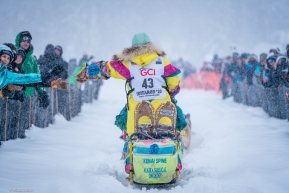 Monica Zappa getting a greeting race fans as she crosses the lake at the Re-start of the 2020 Iditarod in Willow, Alaska.