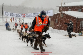 A team of Norwegian Volunteers walks Tore Albrigtsen and team to a parking spot at the Takotna checkpoint during Iditarod 2016.  Alaska.  March 09, 2016.  Photo by Jeff Schultz (C) 2016  ALL RIGHTS RESERVED