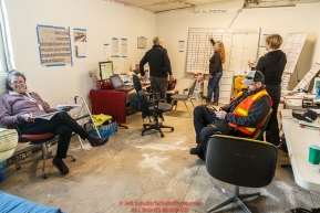 A group of volunteers works the logistics flight room at the McGrath checkpoint during Iditarod 2016.  Alaska.  March 09, 2016.  Photo by Jeff Schultz (C) 2016  ALL RIGHTS RESERVED