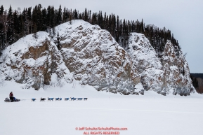 Noah Burmeister runs down the Yukon River past the cliffs of Ruby after leaving the Ruby checkpoint during the 2017 Iditarod on Thursday morning March 9, 2017.Photo by Jeff Schultz/SchultzPhoto.com  (C) 2017  ALL RIGHTS RESERVED