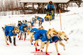 Seth Barnes team rounds a corner as he runs down the road arriving at the Ruby checkpoint during the 2017 Iditarod on Thursday afternoon March 9, 2017.Photo by Jeff Schultz/SchultzPhoto.com  (C) 2017  ALL RIGHTS RESERVED