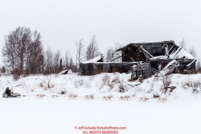 Jim Lanier passes a derelict cabin on the trail into the Iditarod checkpoint on Friday, March 9th during the 2018 Iditarod Sled Dog Race -- AlaskaPhoto by Jeff Schultz/SchultzPhoto.com  (C) 2018  ALL RIGHTS RESERVED