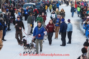 Paige Drobny is escorted to the line by volunteer handlers during the Iditarod 2014 Ceremonial start in downtown Anchorage, Alaska.Iditarod Sled Dog Race 2014PHOTO (c) BY JEFF SCHULTZ/IditarodPhotos.com -- REPRODUCTION PROHIBITED WITHOUT PERMISSION