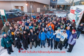 Volunteer dog handlers pose for a group portrait before heading to their assignments during the 2014 ceremonial Iditarod start in downtown Anchorage, Alaska.Iditarod Sled Dog Race 2014PHOTO (c) BY JEFF SCHULTZ/IditarodPhotos.com -- REPRODUCTION PROHIBITED WITHOUT PERMISSION
