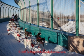 Veteran musher, Karen Ramstead, drives her dogs along the Tudor Road bridge during the ceremonial start to Iditarod 2014  in Anchorage, Alaska.Iditarod Sled Dog Race 2014PHOTO (c) BY JEFF SCHULTZ/IditarodPhotos.com -- REPRODUCTION PROHIBITED WITHOUT PERMISSION